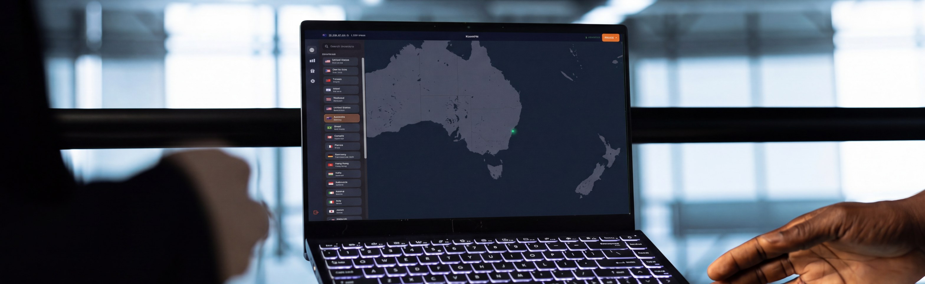 Two people reviewing the KeenVPN server map on a laptop